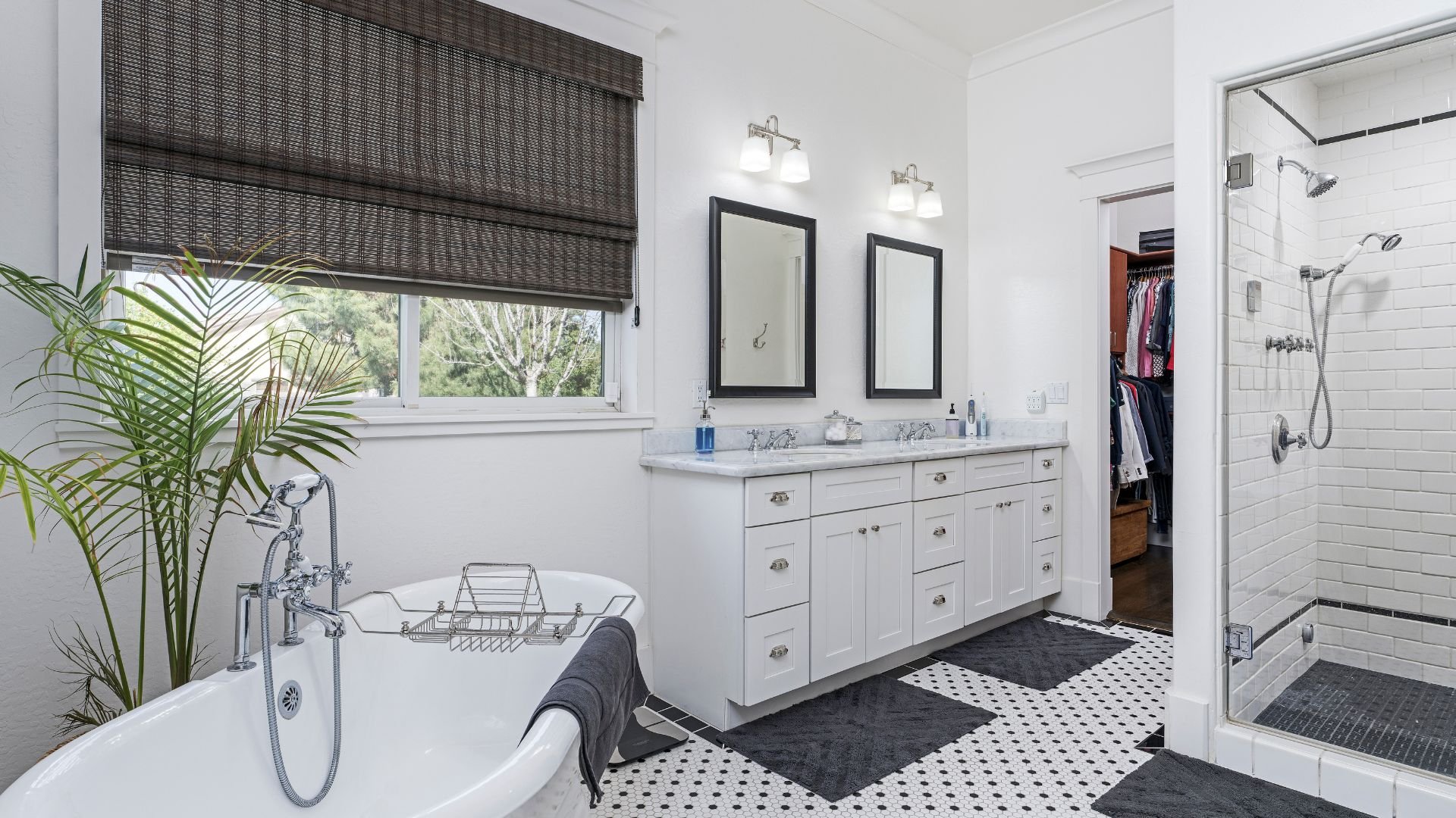Elegant white bathroom with freestanding tub, vanity, and walk-in shower